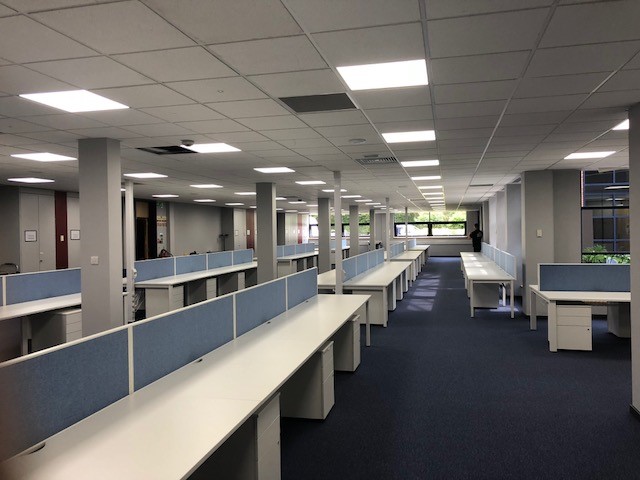 Open Plan Office with white tables and blue divider screens